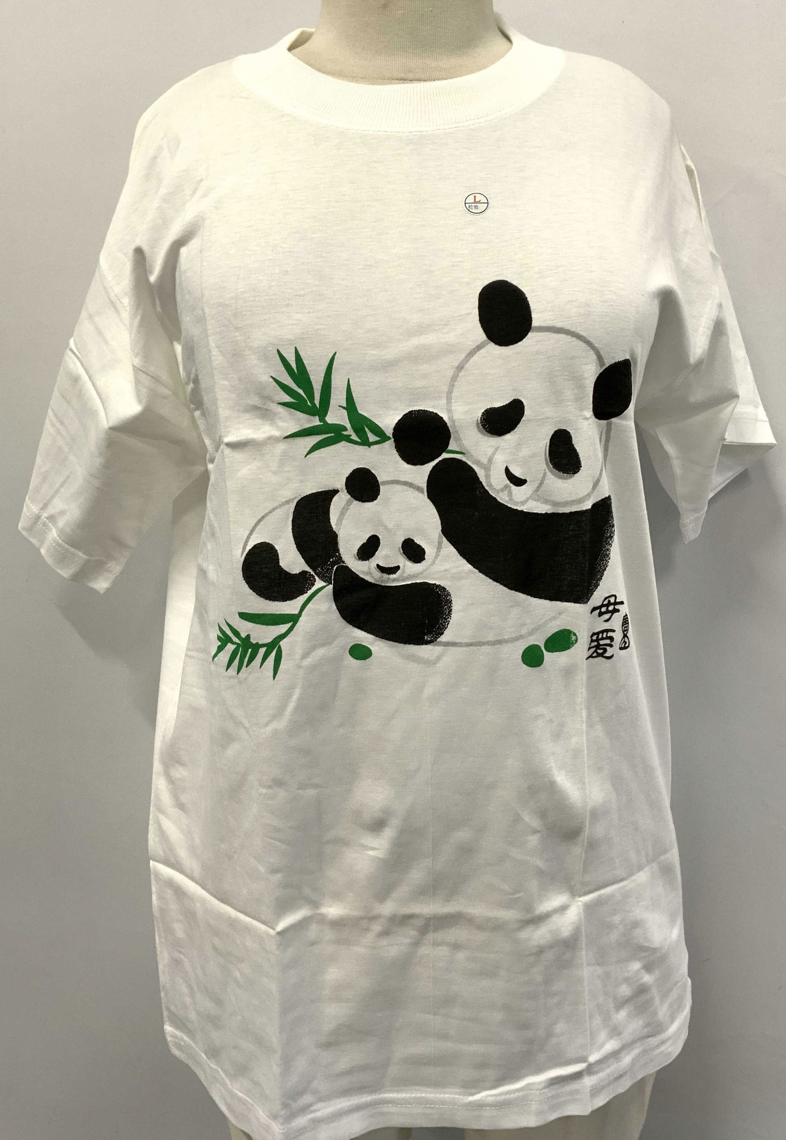 Panda W Bamboo Graphic T-Shirt ASIAN: Panda W Bamboo Graphic T-Shirt ASIAN White t-shirt depicts a large panda & a smaller panda with bamboo leaves. Size LARGE. BRAND NEW IN PLASTIC. Surface wear consistent to age, use & exposure. Graphic