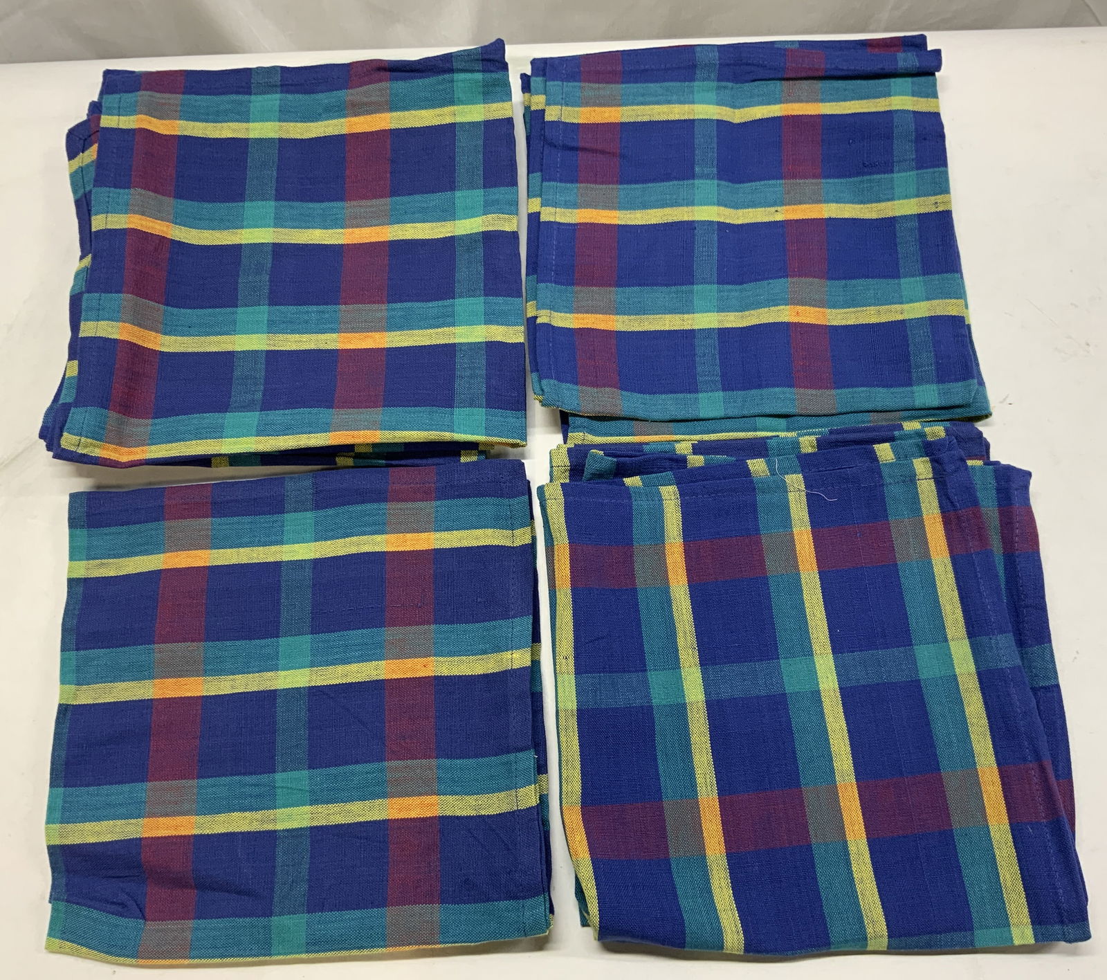 8 TAG Textiles Plain Cotton Napkins INDIA: 8 TAG Textiles Plain Cotton Napkins INDIA 8 TAG textiles plaid napkins. Napkins made in INDIA. Napkins have a plaid pattern with vertical & horizontal lines. Colors including, blue, yellow, red & teal