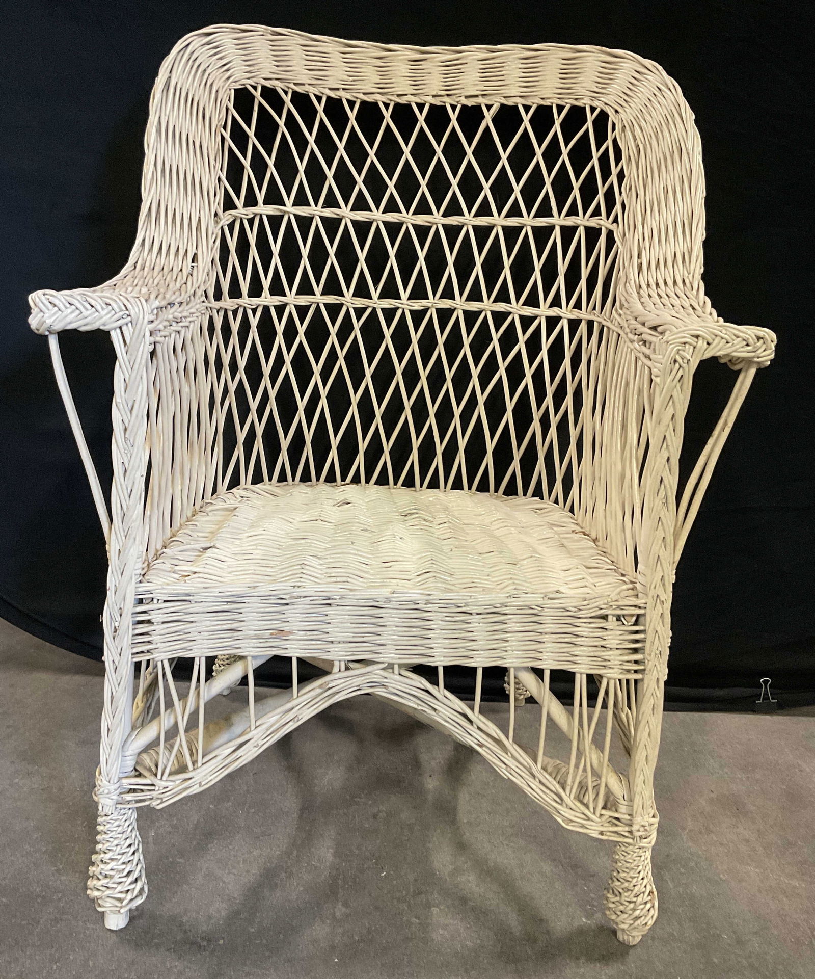 Vintage Woven Wicker Armchair: Vintage Woven Wicker Armchair. Cream hued. Measures approx. 38H x 20D x 26W in. Losses, chipping, discoloration, and surface wear present. Vintage furniture furnishings, seating, occasional chair, sun