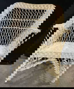 Vintage Woven Wicker Armchair: Vintage Woven Wicker Armchair. Cream hued. Measures approx. 38H x 20D x 26W in. Losses, chipping, discoloration, and surface wear present. Vintage furniture furnishings, seating, occasional chair, sun