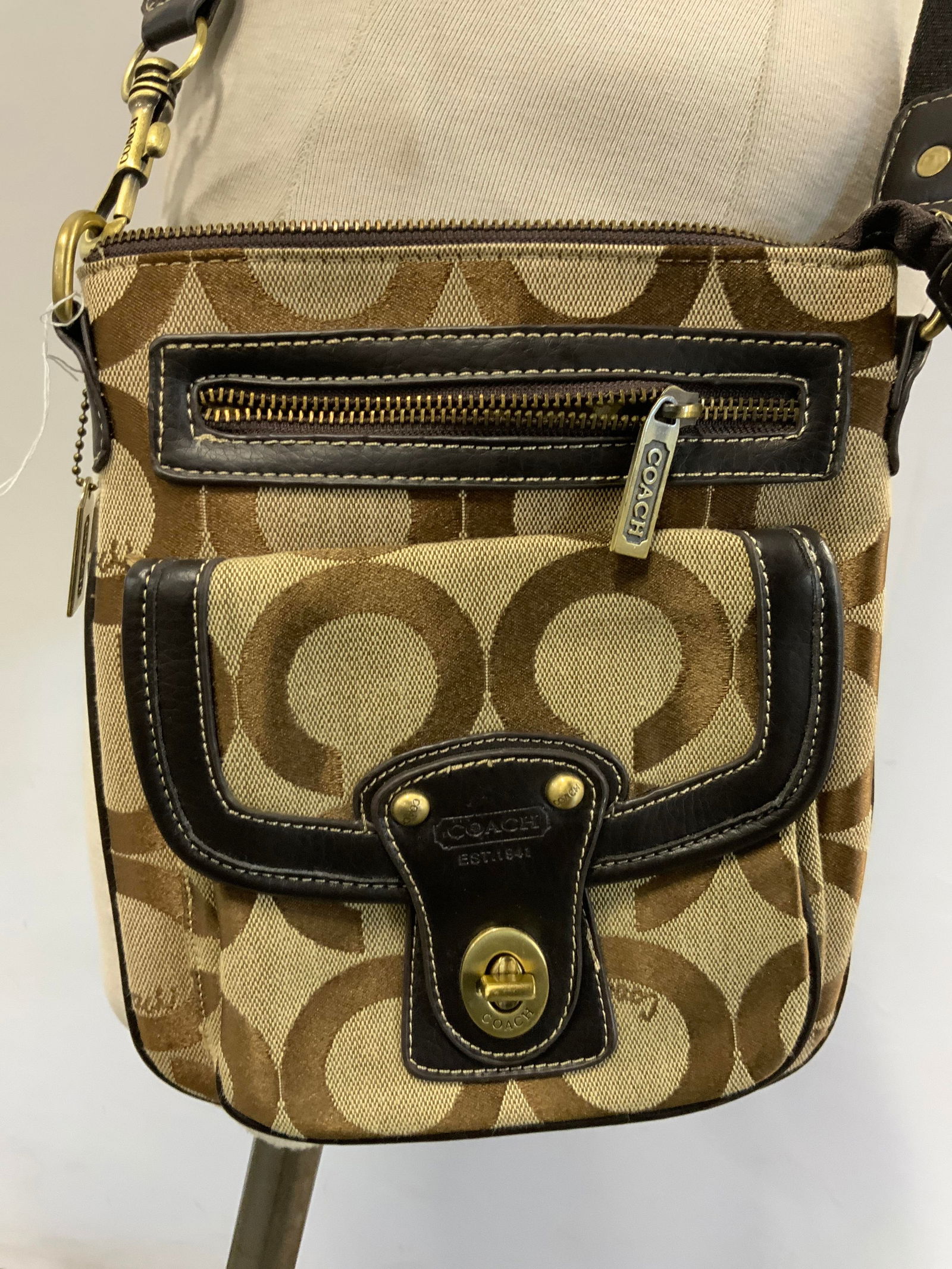 Coach Canvas Brown & Tan Crossbody Bag: Coach Canvas Brown & Tan Crossbody Bag Brown & tan crossbody bag. Front of bag has a lock closure & lettering of COACH EST 1941. Material is canvas & leather. Signed & marked. Surface wear consistent