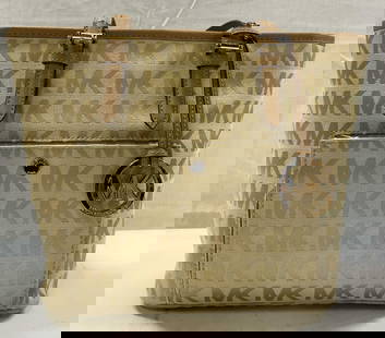Michael Kors Canvas Brown & Tan Handbag: Michael Kors Canvas Brown & Tan Handbag Brown & tan handbag. Front of bag has a MK gold logo charm & a pocket. Interior of bag has zippers. BAG IS BRAND NEW & with packaging. Signed & marked. Surface