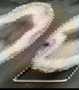 Cut Amethyst Semiprecious Geode Specimen: Cut amethyst geode specimen. Semiprecious stone. Measures approx 4,25 inches wide. Includes metal stand. Some scratching observed. Geode, geode specimens, semiprecious stone, semiprecious stone specim