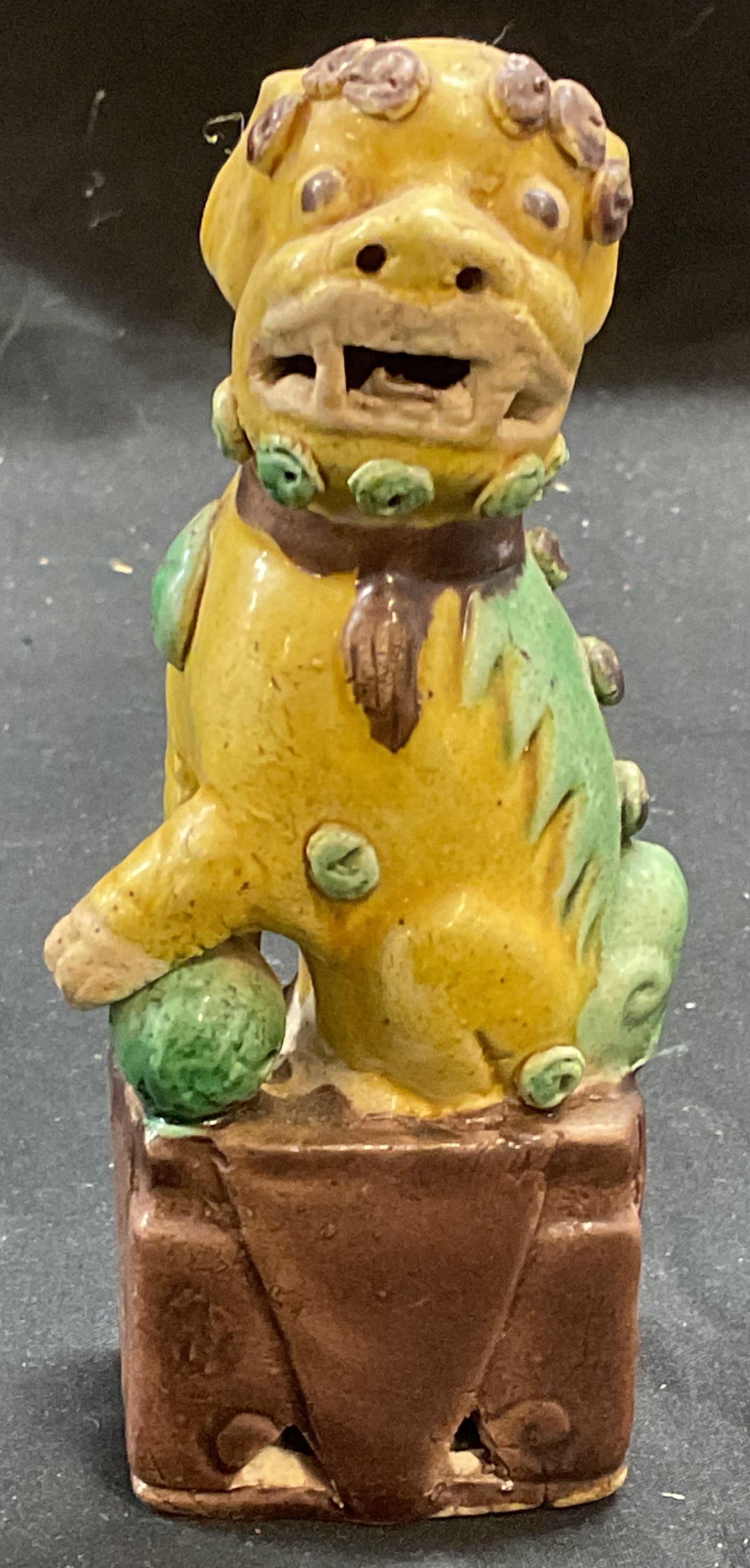 Vintage Chinese Porcelain Foo Dog Figural: Vintage Chinese porcelain foo dog figural. Hand painted in yellow, green, and brown. Measures approx 2.5 x 1.75 x 5.75 inches. Some wear including scratching. Foo dog, foo dog figural, Chinese figural