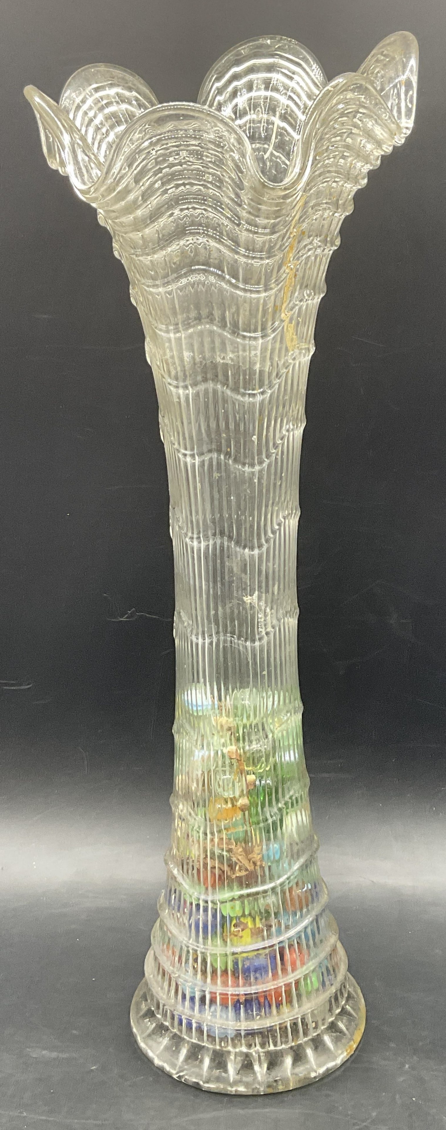 Vintage Swung Glass Vase W/ Vintage Glass Marbles: Vintage Swung Glass Vase With Vintage Glass Marbles. Colorless glass vase partially filled with glass marbles. Done marbles feature swirled coloring. Vase measures approx. 18.25H x 6W in. Discoloratio