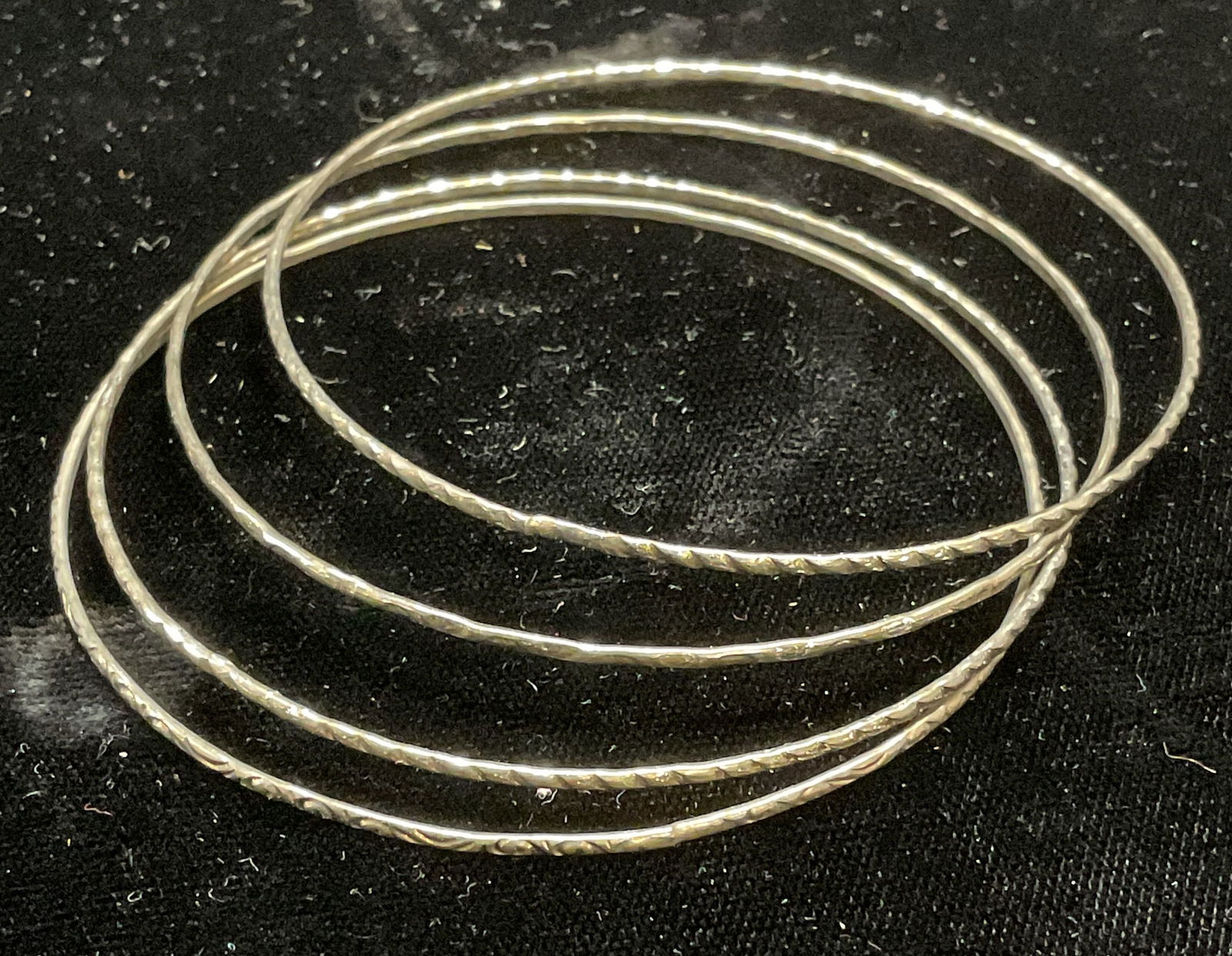 Set 4 Vintage Silver Tone Stacking Bangles: Set of 4 Vintage silver tone stacking bangles with textured bands. Measure approx 2.5 inches wide each. Some wear including scratching observed. Jewelry, estate jewelry, fashion jewelry, cocktail jewe