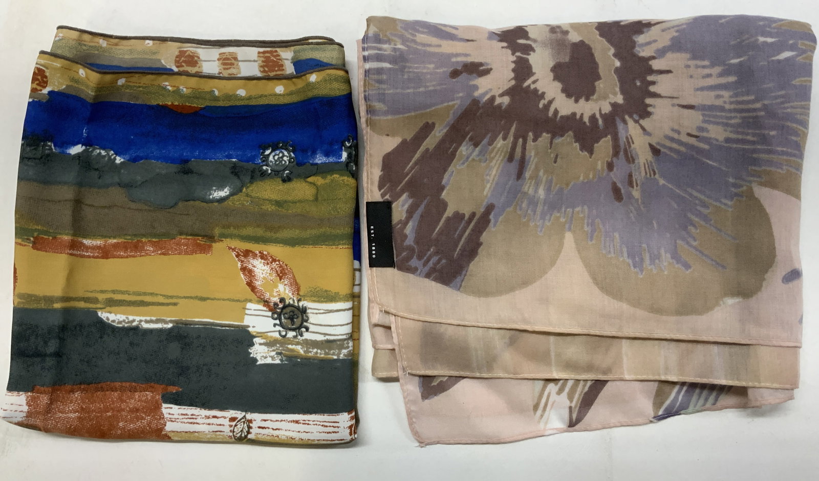 2 Floral & Abstract Print Scarves FRAAS & More: 2 floral & multicolor scarfs. 1 scarf reads FRAAS. BRAND NEW WITH TAGS. Tags read 100% polyester. Signed & marked. Surface wear consistent to age, use & exposure. Measurements: length 61.5in x width 1