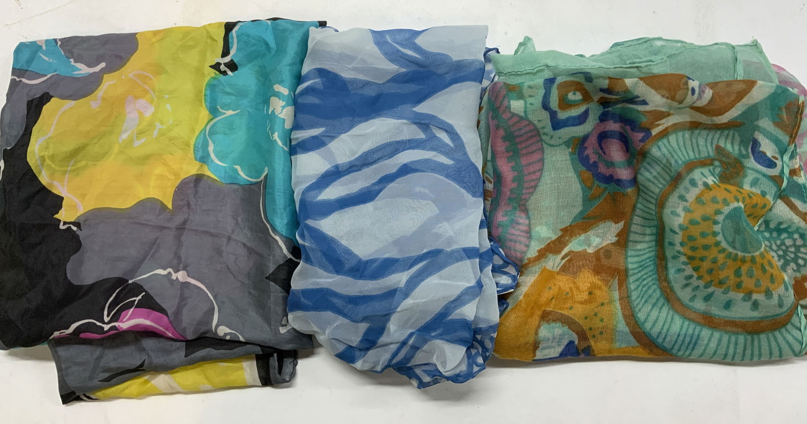 3 Scarves, Silk Road, Brunel Japan, & More: 1 scarf has a label that reads SILK ROAD, 100% silk. 1 scarf reads BRUNEL, MADE IN JAPAN. scarves are multi-color & appear to be silk, linen & more. Signed & marked. Surface wear consistent to age, us