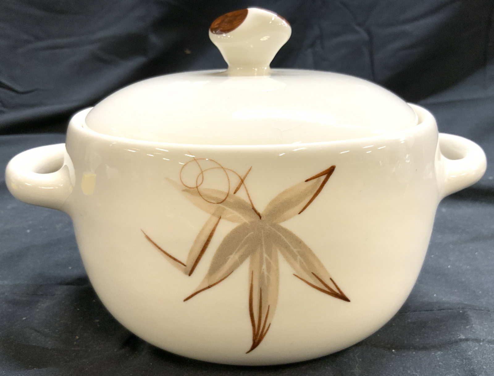 WINFIELD Handcrafted Ceramic Serv Bowl W Lid Calif: Underside is marked WINFIELD China California. Serving bowl is hand crafted as reads on underside. Bowl has handles at sides. Piece is cream with tan toned leaf detail. Serving bowl measures approxima