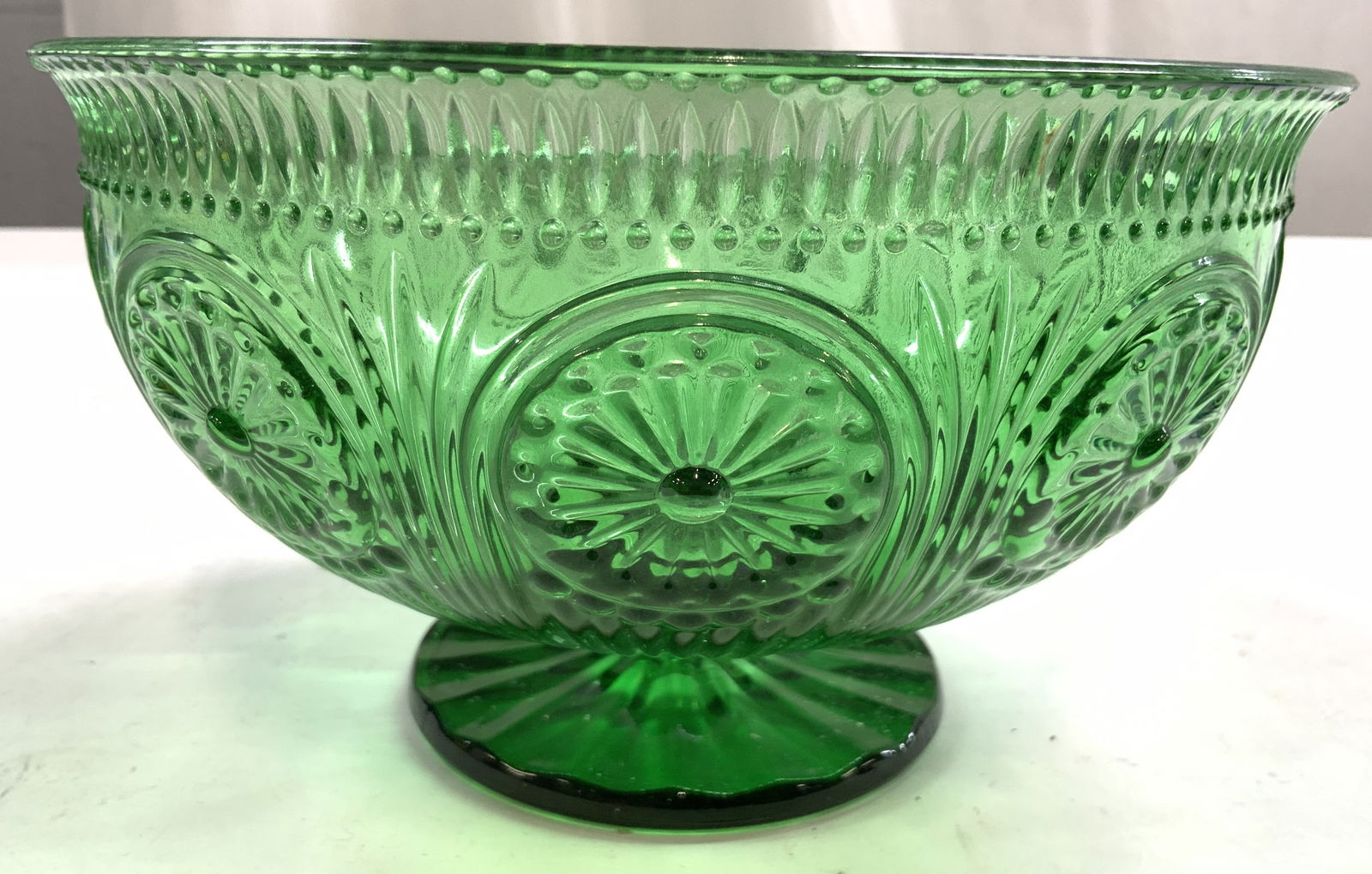 Vtg Emerald Green Art Glass Ciborium Vessel: Vessel is emerald green toned. Ciborium has intricate geometric relief detail. Piece is footed. Appears to be vintage. Ciborium measures approx 8 inches wide 4.5 inches tall. Vessel, Ciborium, candy d