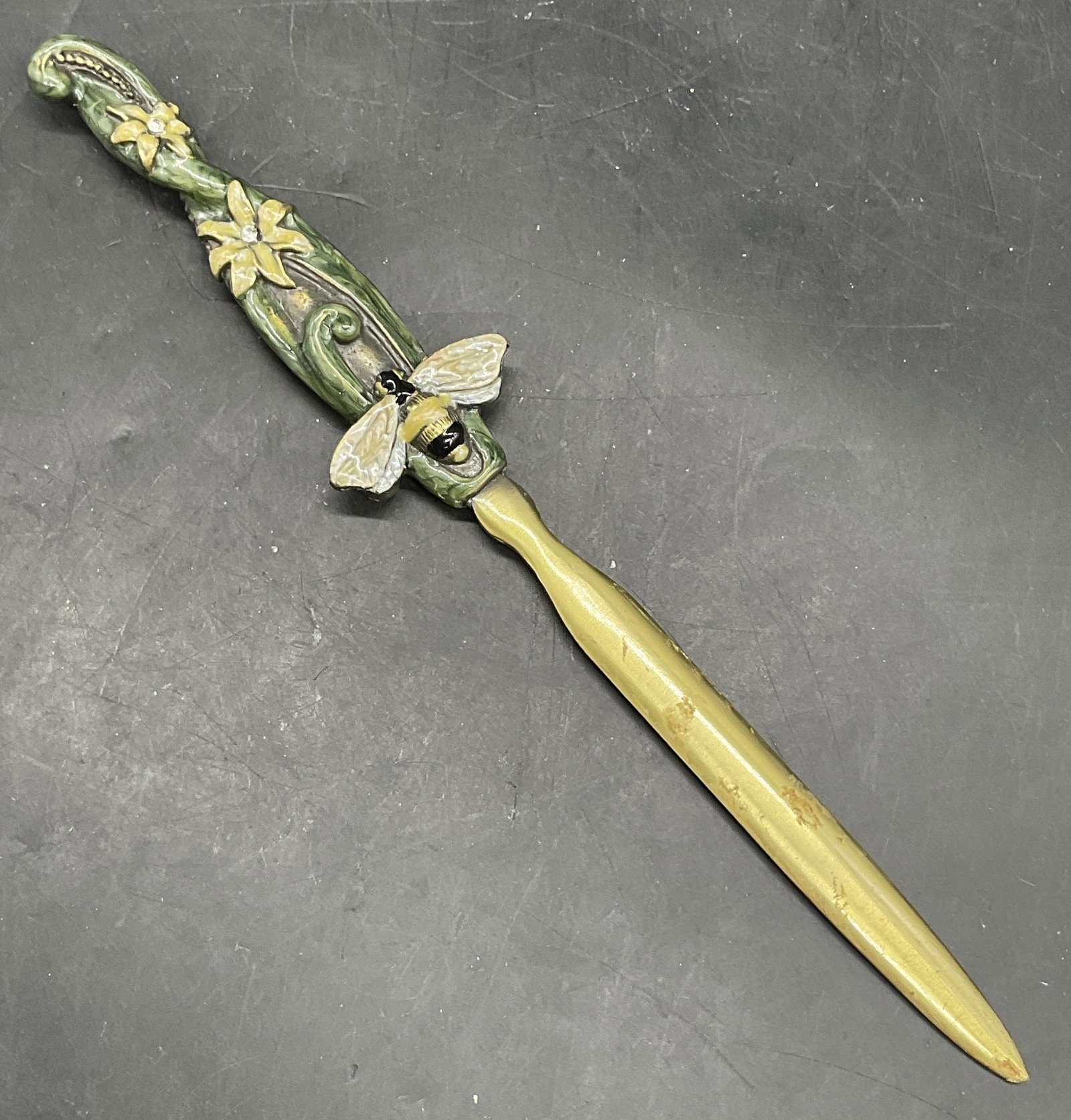 Vintage Enameled Floral & Bee Motif Letter Opener: Vintage Enameled Floral & Bee Motif Letter Opener. Crafted from brass and decorated with enamelwork and faceted crystals. Measures approx. 8L x 1.25W in. Chipping, discoloration, and residue present. 
