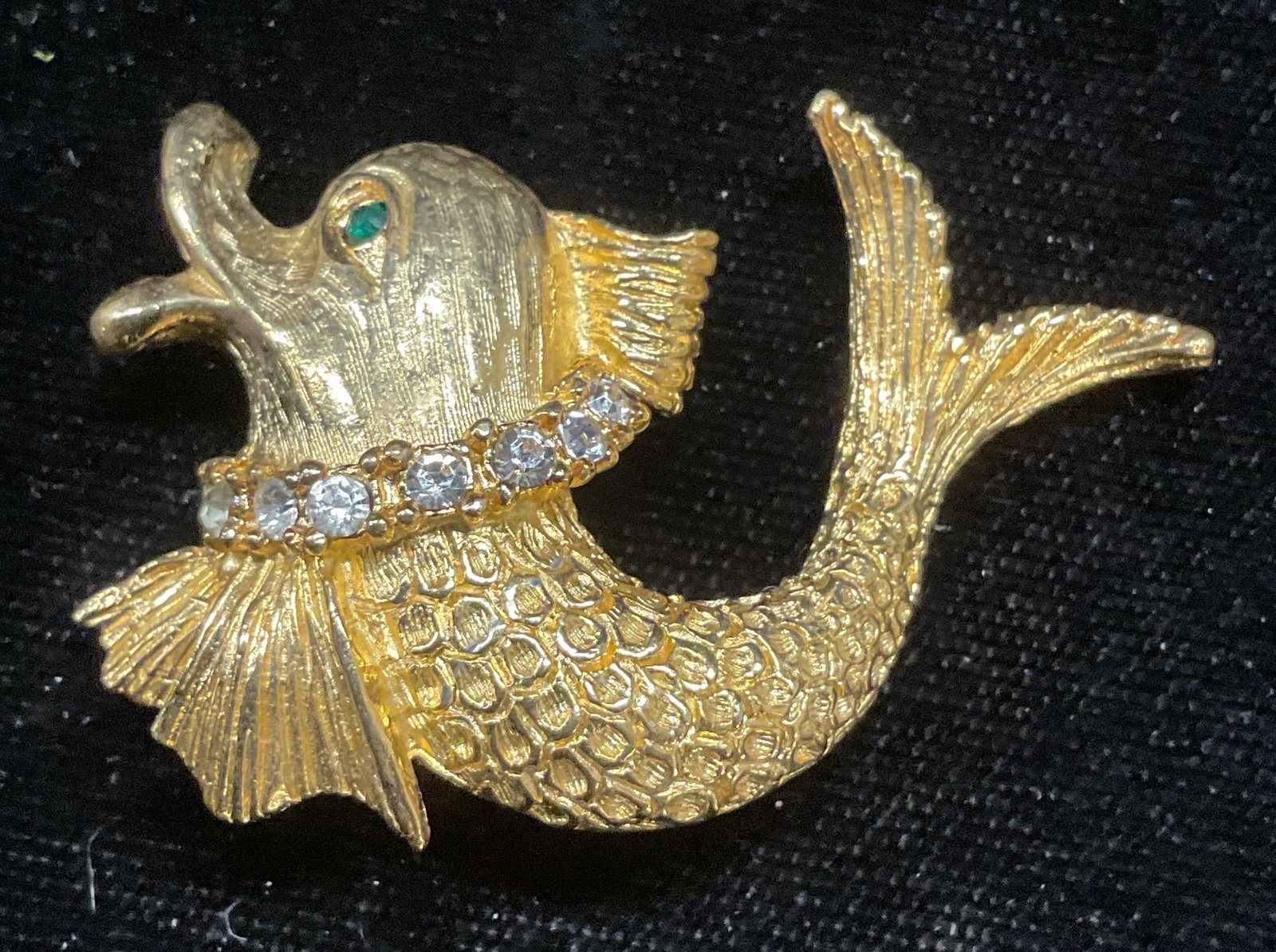 Vintage Gold Tone Crystal Fish Brooch: Vintage gold tone fish motif brooch with green and colorless crystal. Measures approx 1.25 x 1.75 inches. Some wear including scratching observed. Inventory from Manhattan Jewelry store circa 1950s-19