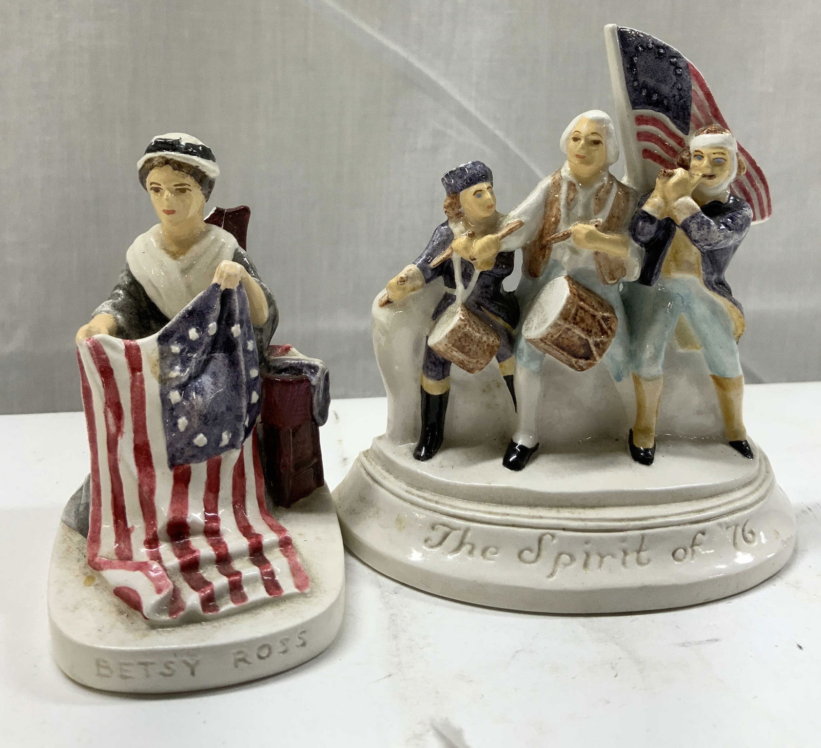 2 Vntg Revolutionary Miniatures Figs: 2 Vintage Sebastian Revolutionary Miniatures Figs. 2 miniatures ceramic figurines depicting Betty Ross sitting down & holding a U.S. flag & spirit of 76 figurine. Figurines depict revolutionary war so