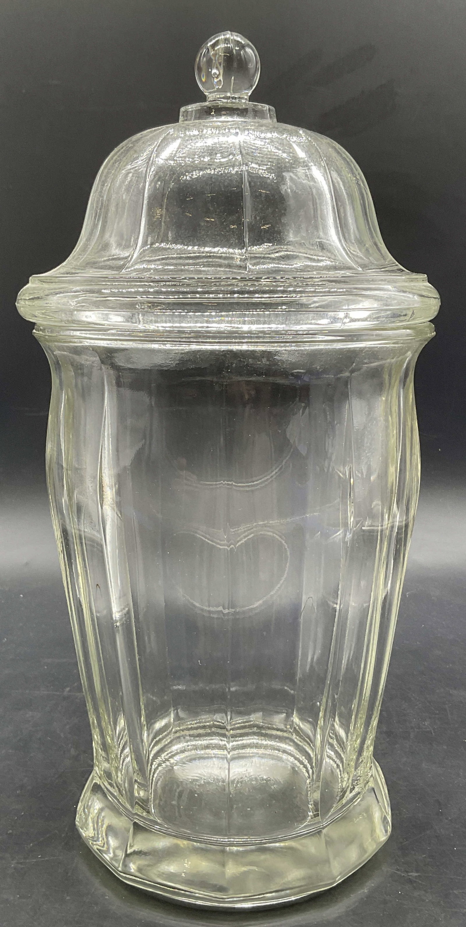 Vintage Lidded Clear Glass Paneled Apothecary Jar: Vintage Lidded Clear Glass Paneled Apothecary Jar. Spherical finial to the lid. Measures approx. 11.5H x 5.5W in. Seam and bubbles present. Surface wear consistent with age, use, and exposure. Imperfe