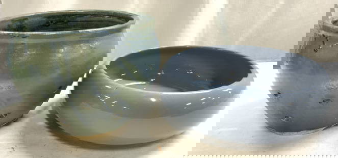 Lot 2 Ceramic Planter & US LEISURE Prod Bowl: Underside of bowl has tag which reads US LEISURE PRODUCTS. Lot includes 1 ceramic planter with pierced detail & 1 light blue toned bowl. Planter measures approximately 5.5 inches tall 7.5 inches wide.
