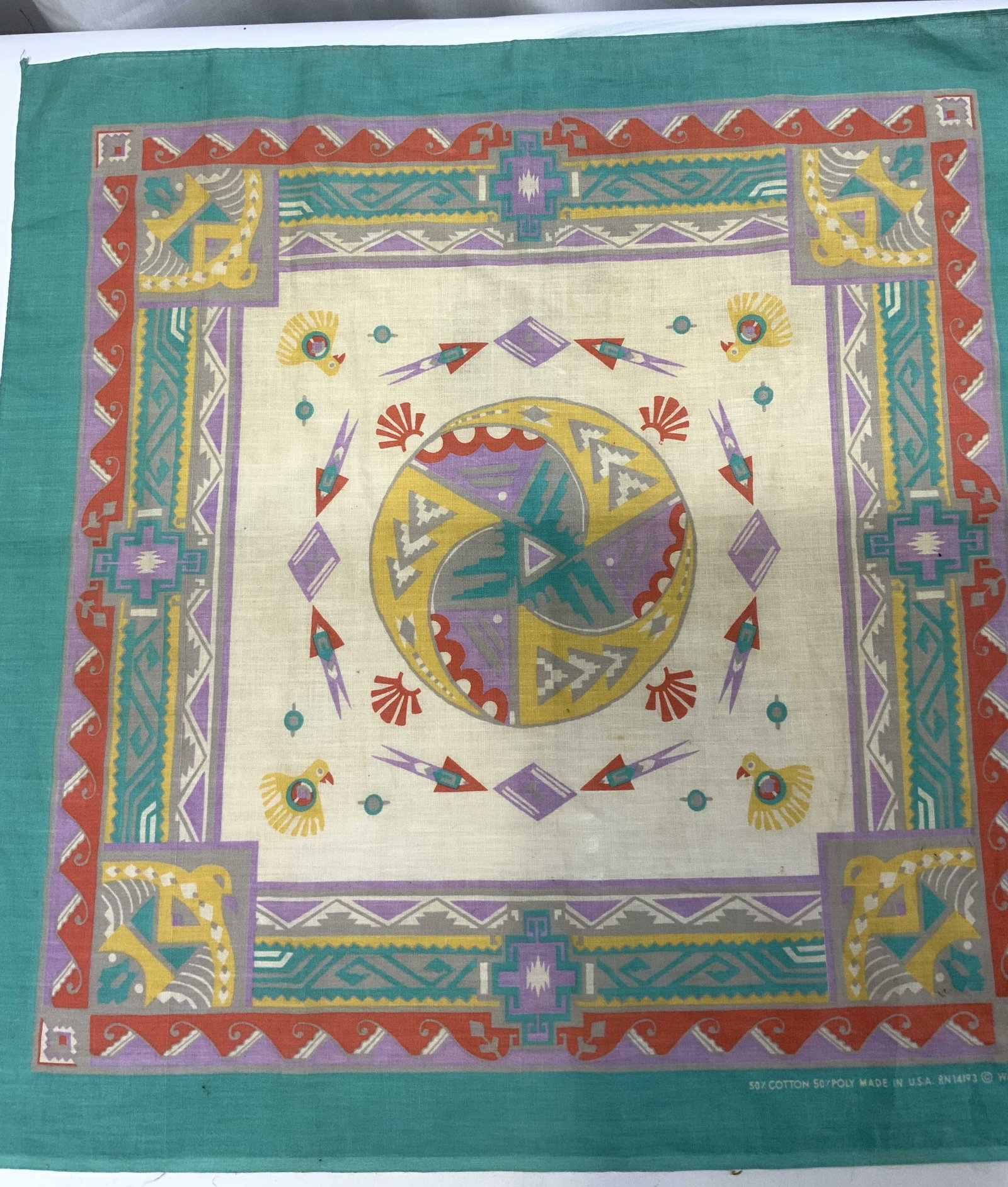 WAMCRAFT Aztec Native Eagle Teal Scarf: WAMCRAFT Aztec Native Eagle Teal Scarf Scarf that features a Native American Aztec design. Scarf has eagles on the corners. Scarf also features a colorful geometric pattern with a circular center desi