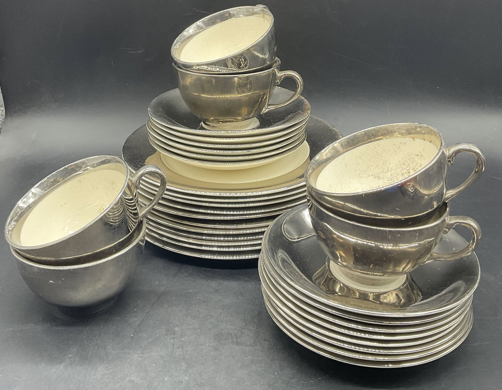 Set 31 GRAYS POTTERY ENGLAND Silver Tone Tableware: Set 31 GRAYS POTTERY ENGLAND Tableware. Includes teacups, saucers, and plates. The plates measure approx. 8L x 8W in. Silver tone metallic accents to the pieces. Undersides are signed GRAYS POTTERY ST