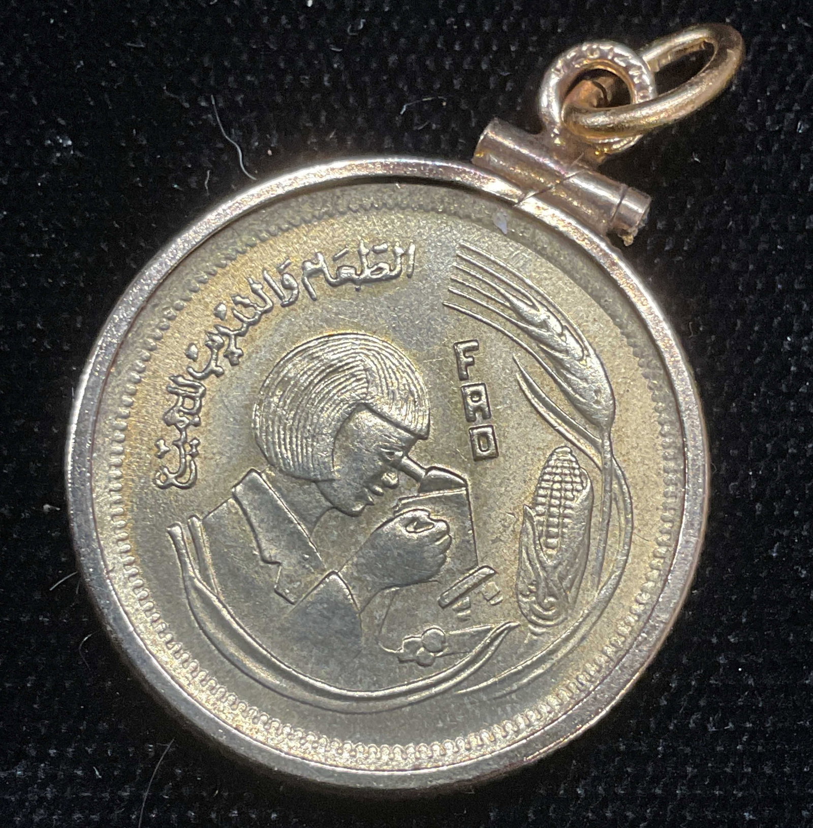 Vintage Gold Tone Coin Pendant: Vintage gold tone coin pendant. Image of a woman with microscope. Measure approx .75 inches wide. 12k gold filled outer and bail. Includes box. Some wear including scratching observed. Jewelry, estate
