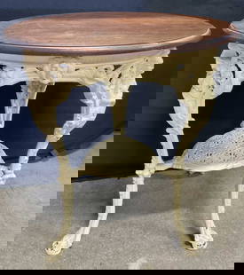 Vintage Wood & Iron Figural Claw Footed Table: Vintage Victorian Style Wood & Iron Figural Claw Footed Table. Round wooden top with a painted white iron base. Figures, florals, and lion heads throughout the base. Measures approx. 25W x 25D x 29.5H