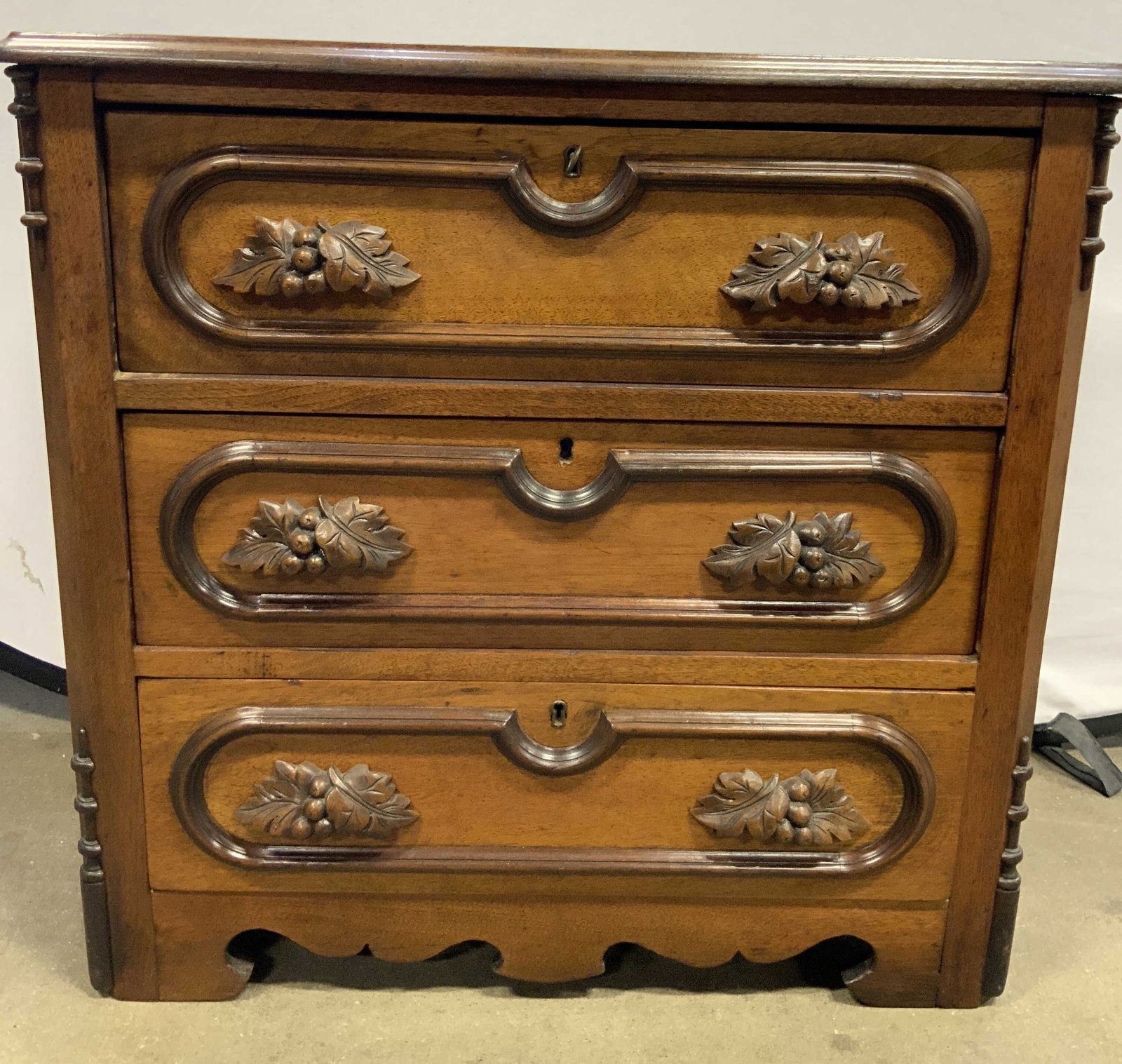 Antique Carved Wooden East Lake Dresser: Dresser appears to be antique possibly vintage. Piece has carved wooden berry and leaf handles. Dresser has 3 drawers each with hand dovetailing. Dresser measures approximately 29 inches tall 30 inche