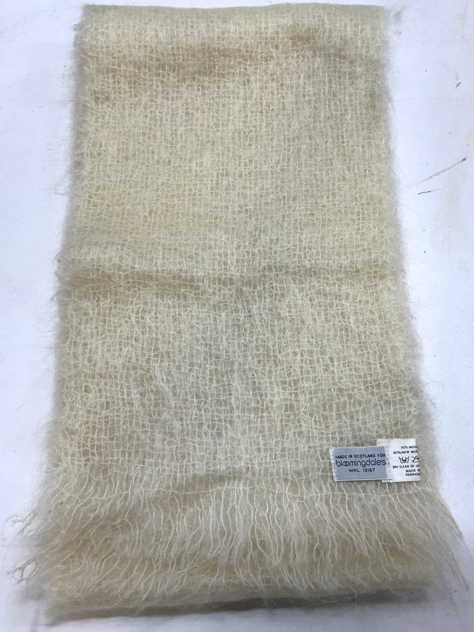 BLOOMINGDALES Long Mohair Scarf SCOTLAND: BLOOMINGDALES Long Mohair Scarf SCOTLAND Long ivory scarf made of Mohair & Wool. Tag reads, Made in Scotland for Bloomingdales. 70% MOHAIR & 30% new wool. Signed & marked. Surface wear consistent to a