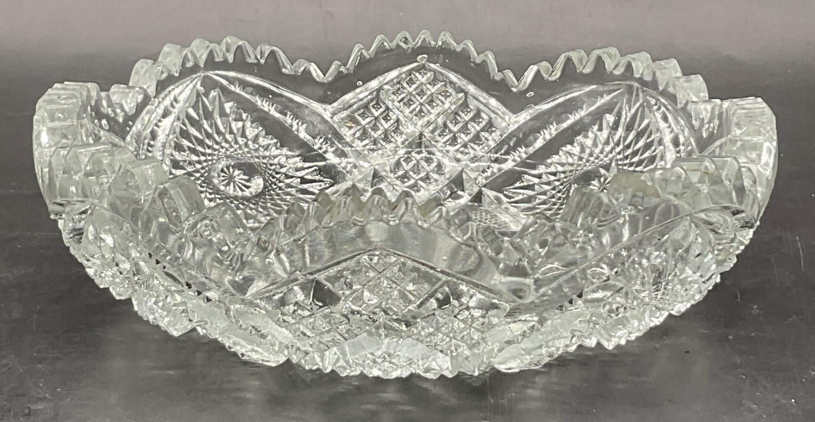 NUCUT Vintage Cut Glass Sawtooth Rim Candy Dish: Vintage Cut Glass Sawtooth Rim Candy Dish. Obverse center reads NUCUT. Thick walled. Measures approx. 6.5W x 2H in. Chipping, discoloration, and surface wear present. home decor, home accents, homewar