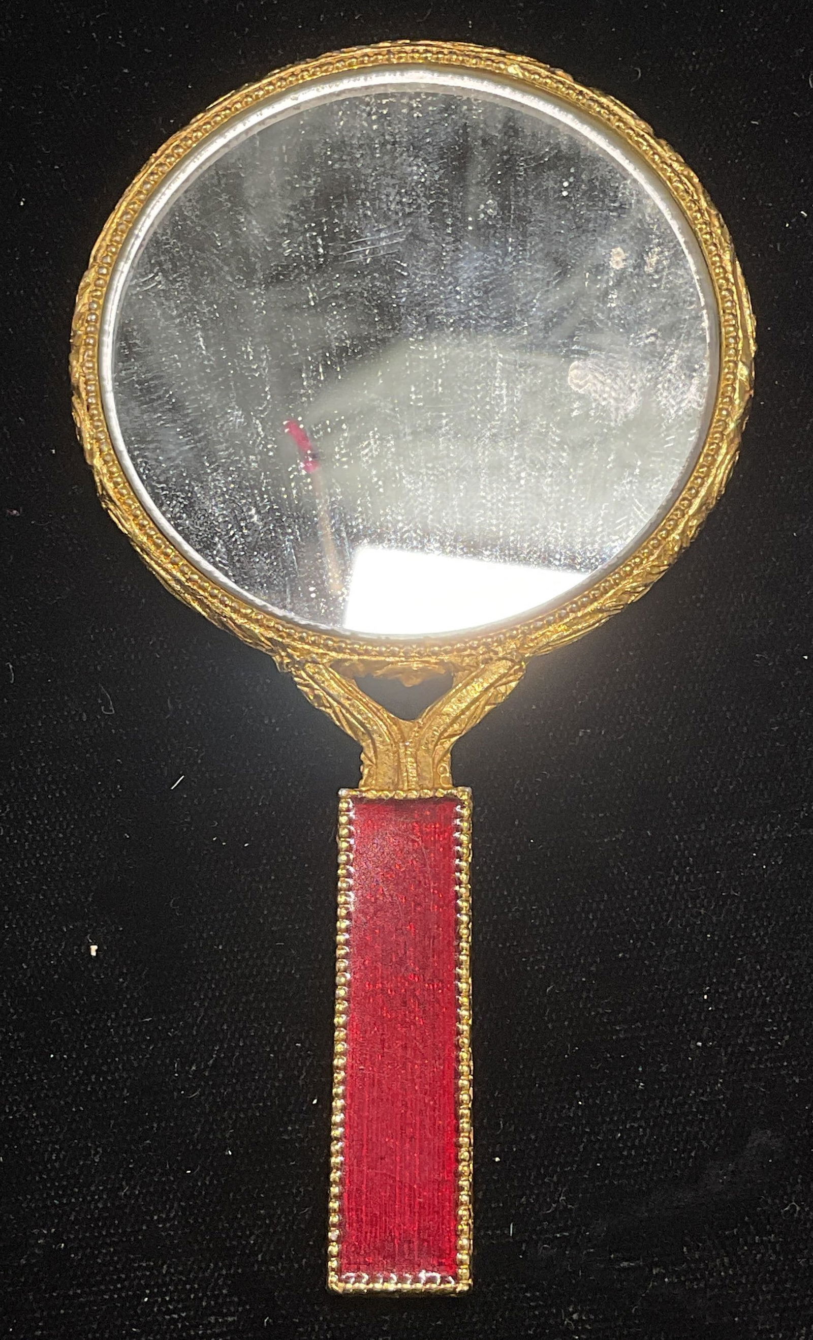 Vintage Gold Tone Red Lacquer Hand Mirror: Vintage gold tone hand mirror with red lacquer decorated handle. Measures approx 4.5 x 2.5 inches. Some wear consistent with exposure. Inventory from Manhattan Jewelry store circa 1950s-1960s. Mirror,