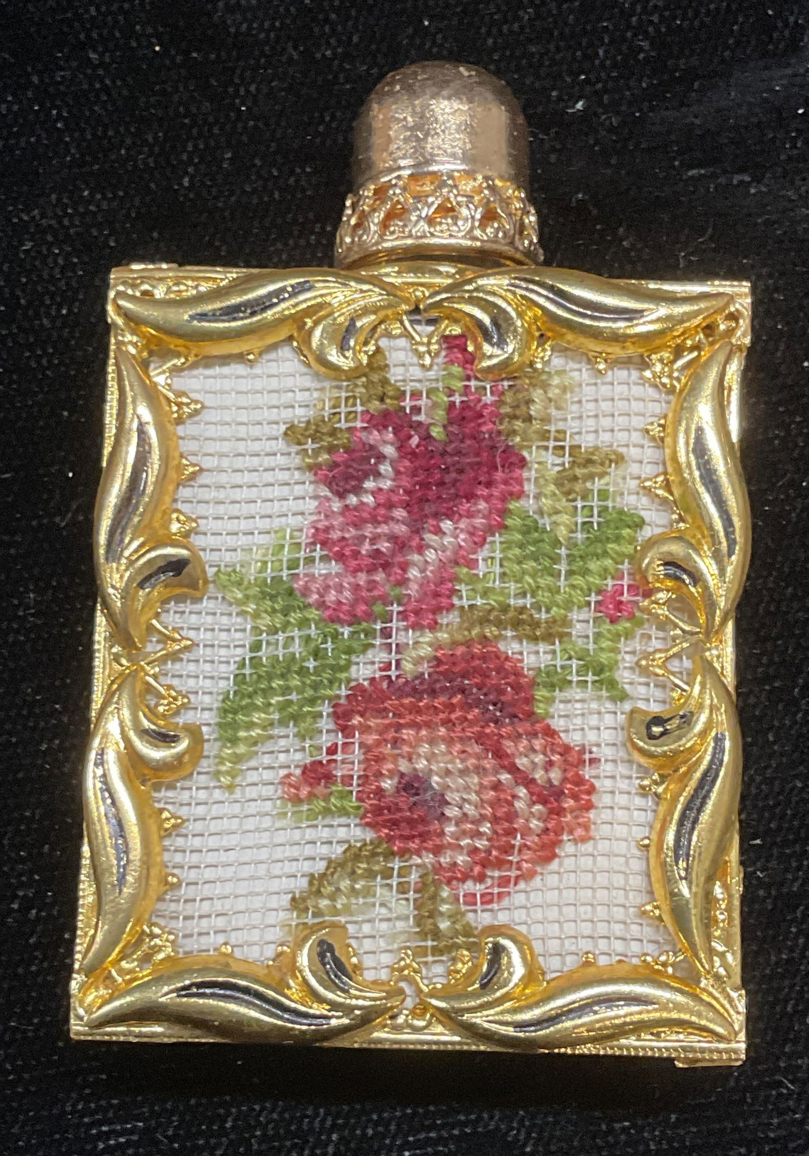Vtg Gold Tn Glass Petitpoint Perfume Bottle: Vintage glass perfume bottle with gold tone filigree outer and needlepoint panel with floral motif. Measures approx 1.25 x 1.5 x .25 inches. Some wear consistent with exposure. Inventory from Manhatta