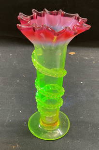 Vtg Yellow Vaseline Uranium Glass Vase: Vintage hand blown Vaseline uranium glass vase. Ruby red to yellow green, fluoresces bright green under UV light. Ruffled rim with raised swirl on body. Measures approx 3.75 x 7 inches. Some scratchin