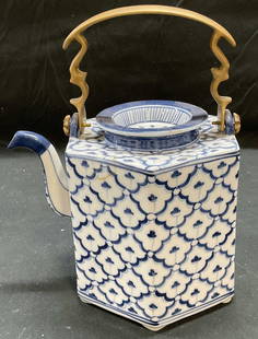 Asian blue & White Porcelain Flower Teapot: Asian blue and white hand painted porcelain teapot with brass handle. Made in Thailand. Measures approx 7 x 5.5 x 5 inches excluding handle. Some scratching observed. Teapot, porcelain teapot, blue an