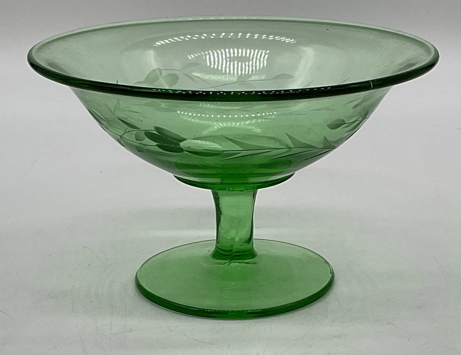 Vintage Green Depression Glass Footed Bowl: Vintage green depression glass footed bowl with fluted rim and etched floral design. Measures approx 6 x 4 inches. Some scratching observed. Depression glass bowl, green bowl, footed bowl, glass bowl,