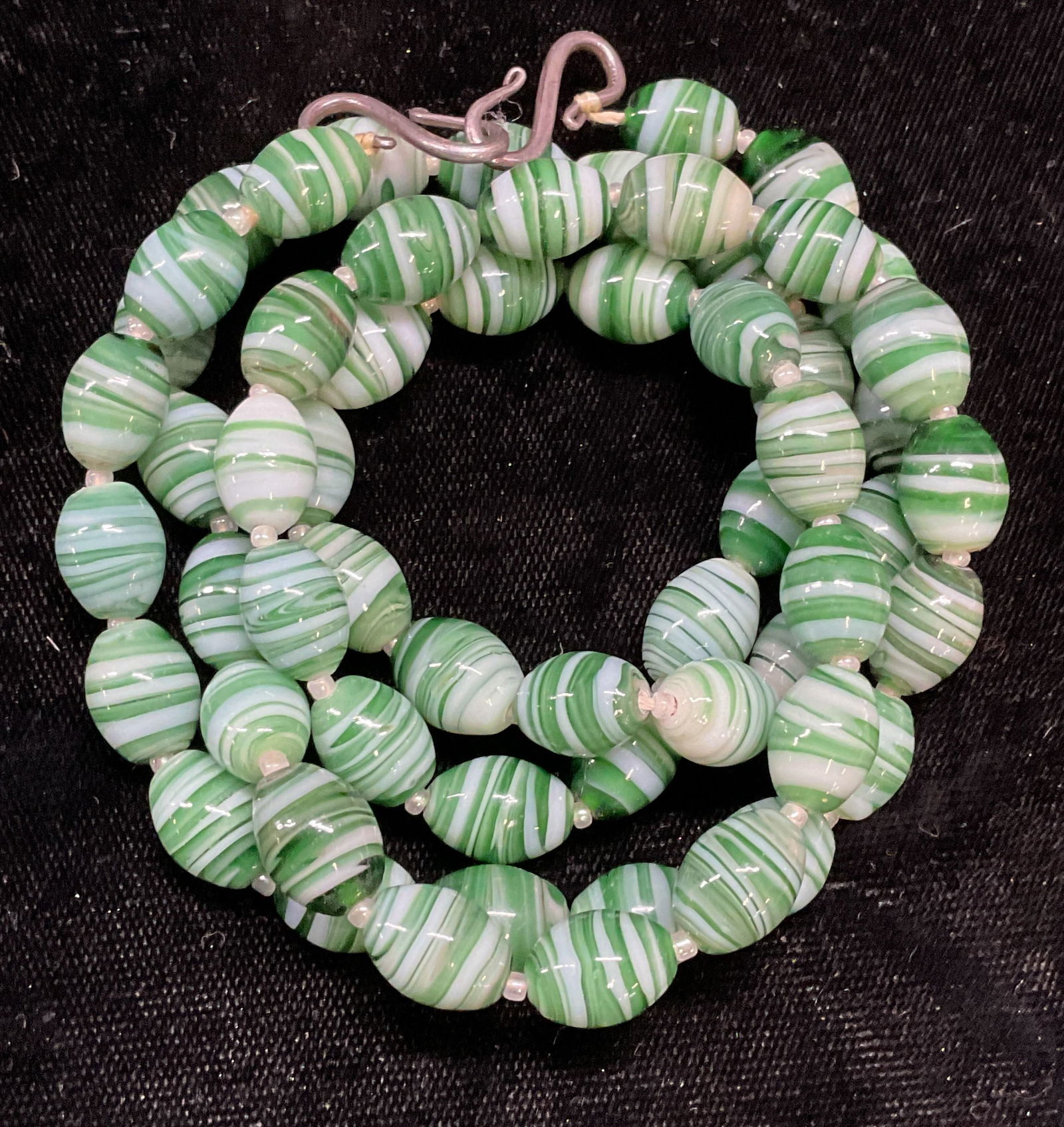 Vintage Green Art Glass Beaded Necklace: Vintage green swirl art glass beaded necklace. Drop length approx 13 inches. Some wear including scratching observed. Jewelry, estate jewelry, costume jewelry, fashion jewelry, cocktail jewelry, acces