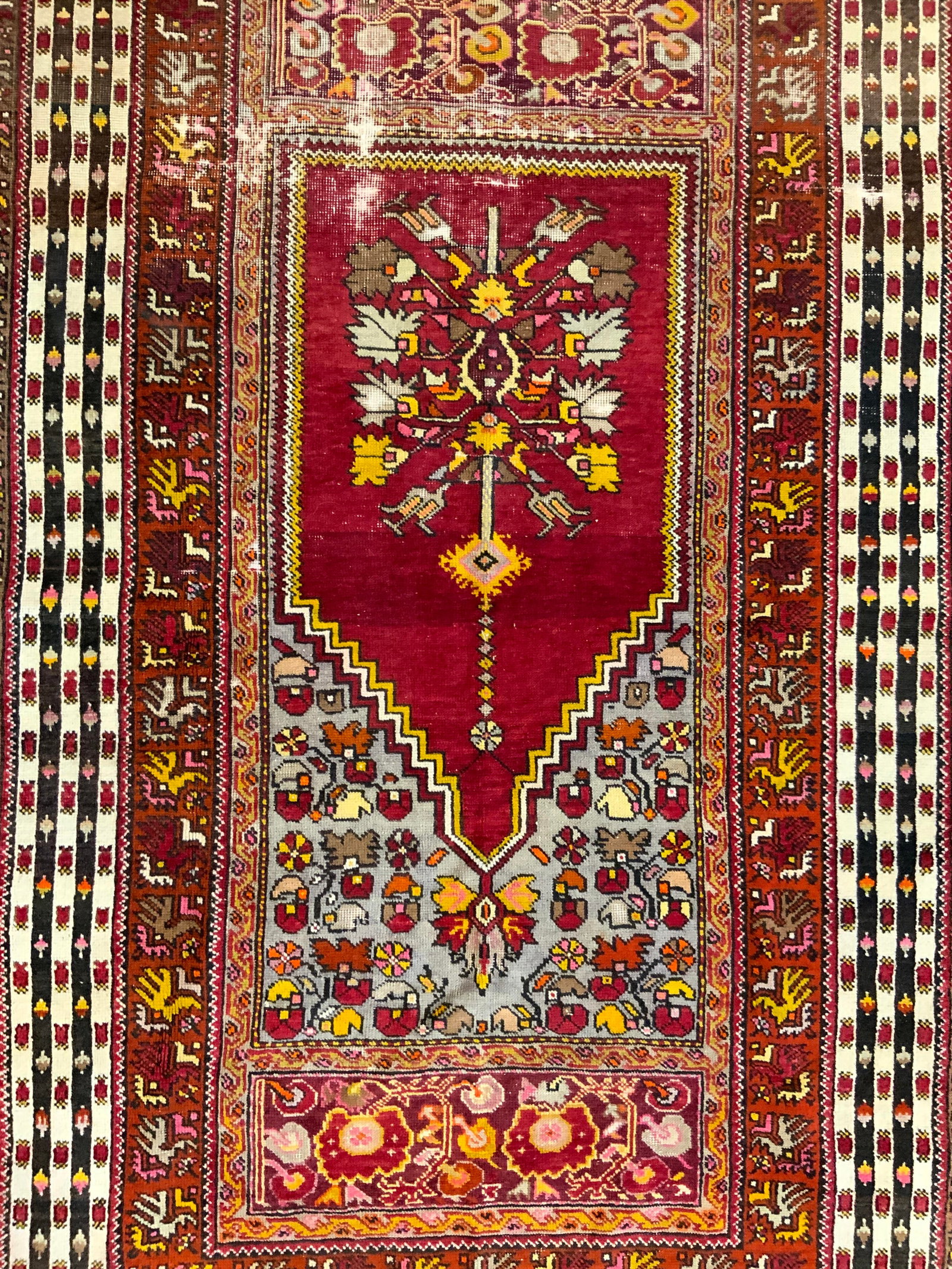 Vintage Handmade Anatolian Wool Area Rug: Rug is handmade and wool. Piece is vintage, appears to be Anatolian. Rug has intricate multi toned floral motif detail. Short cream toned fringes at edges. Measures approximately 81 inches long 49 inc