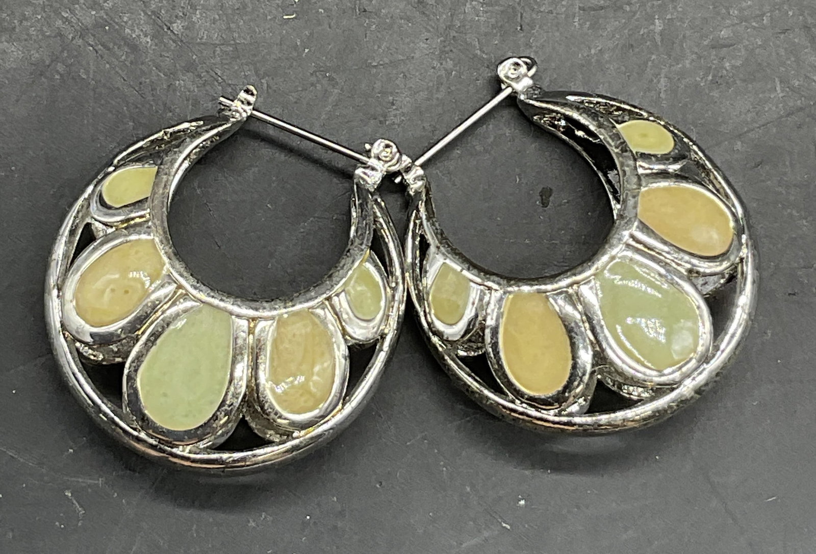 Vintage Enameled Chunky Drop Snap Hoop Earrings: Vintage Enameled Chunky Drop Snap Hoop Earrings. Crafted from silver toned metal and decorated with light orange and green hued enamelwork. Measures approx. 1.25L x 1W in. Surface wear and discolorati