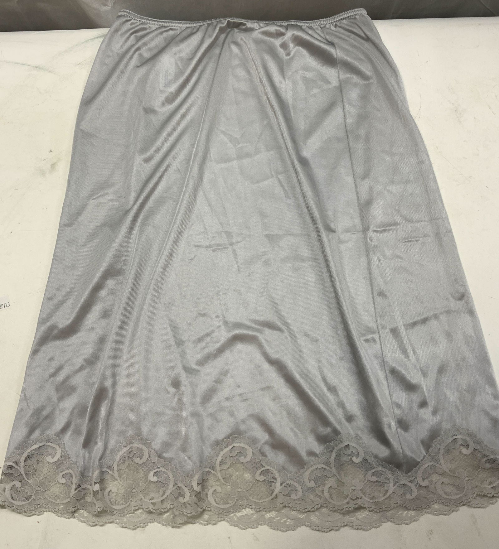 SWEET NOTHINGS Grey Lace Half Slip Skirt: SWEET NOTHINGS Grey Lace Half Slip Skirt Grey half slip skirt with a lace trim at the hem. Signed & marked. Tag reads Sweet Nothings. Maidenform. SIZE L. Surface wear consistent to age, use & exposure