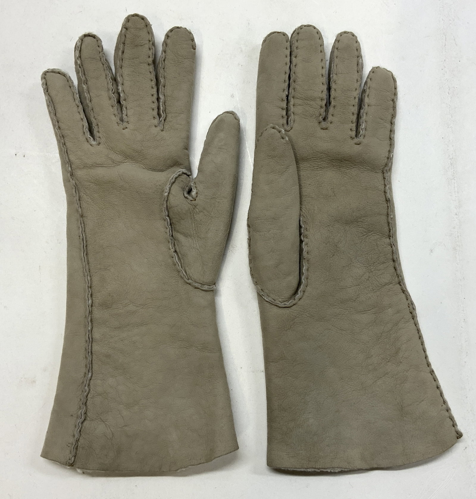 SAKS FIFTH AVENUE Grey Suede Gloves ITALY: SAKS FIFTH AVENUE Grey Suede Gloves ITALY Grey suede gloves with plush lining. Visible signature & markings. Reads MADE EXPRESSLY FOR SAKS FIFTH AVENUE. MADE IN ITALY. Size 7 1/2. Surface wear consist