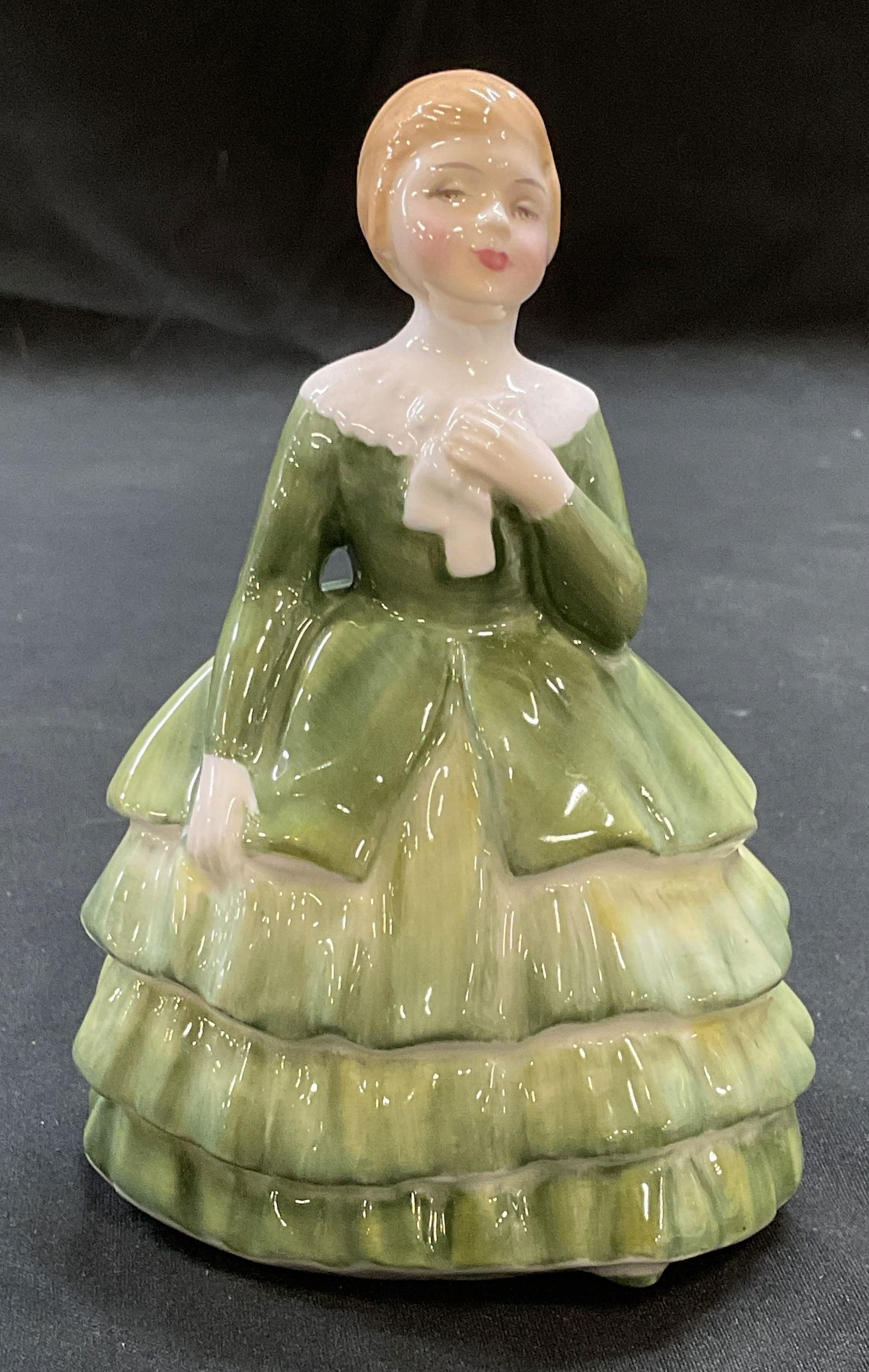 Royal Worcester Belle Bone China Figurine England: Royal Worcester fine bone china figurine. Belle. Girl in green dress. Signed. Hand painted. Made in England. Measures approx 3 x 2.5 x 4.75 inches. Some wear consistent with exposure. Royal Worcester,