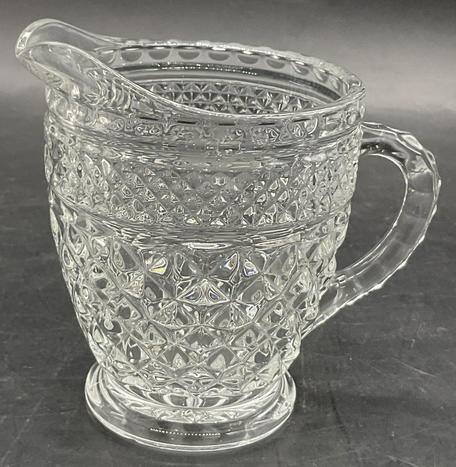 Vintage Cut Glass Creamer: Vintage Cut Glass Creamer. Measures approx. 4.25H x 4.5W in. Measured at widest point. Glass seam present. Chipping and surface wear to the piece. home decor, home accents, homewares, housewares, home