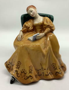 ROYAL DOULTON Romance Porc Figurine ENGLAND: ROYAL DOULTON Romance Porc Figurine ENGLAND Porcelain figurine depicting a woman seated in a dark green armchair. Women is wearing a light orange dress. Signed & marked on underside. Surface wear cons