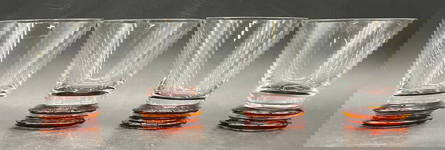 Set 4 Signed Glasses W/ Rimmed Footed Bases: Set of Four Signed Glasses With Rimmed Footed Bases. Clear glass upper portions with orange-red hued bases. The undersides are signed, illegible. Measures approx. 4H x 3.5W in. Slight variations in si