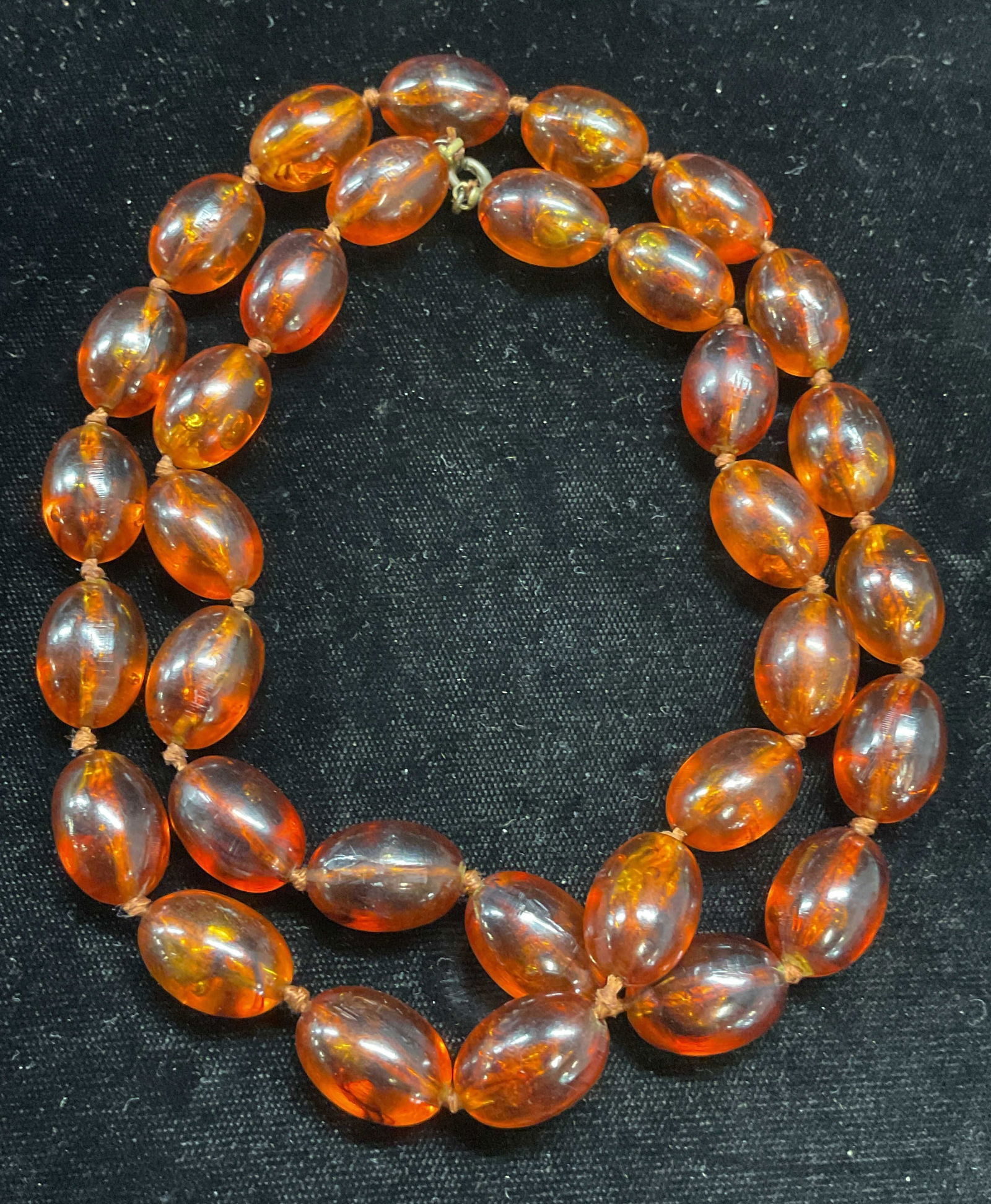 Vintage Amber Beaded Necklace: Vintage pressed Amber beaded necklace on double knotted string. Drop length approx 12 inches. Some wear including scratching observed. Jewelry, estate jewelry, costume jewelry, cocktail jewelry, fashi