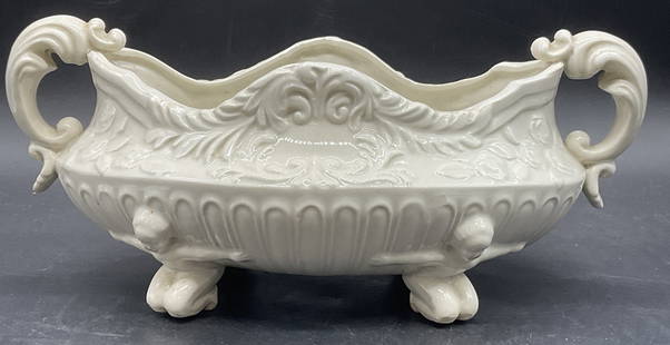 Vintage Figural Footed Embossed Ceramic Bowl Japan: Vintage Figural Footed Embossed Ceramic Bowl. Four feet to the bowl in the form of kneeling figures. Scrolled handles and embossed ceramic details to the piece. Underside reads Made in Japan. Chipping