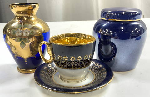 Lot 5 Tableware JSK Porc Teacup & Saucer, And More: Underside of teacup and saucer read JSK . Each are white and blue with gilt floral pattern detail. Lot includes 1 teacup & saucer, 1 vase, & 1 jrm with lid. Vase is cobalt blue with gilt scroll, and m
