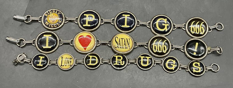 Lot 3 Phrase Charm Bracelets, PigglyWiggly+: Three Phrase Charm Bracelets. Pieces secure with metal clasp closures. One reads I Love Drugs. Another reads Pig, 666, and Piggly Wiggly. Pieces are similar in length measuring approx. 7.75 inches end