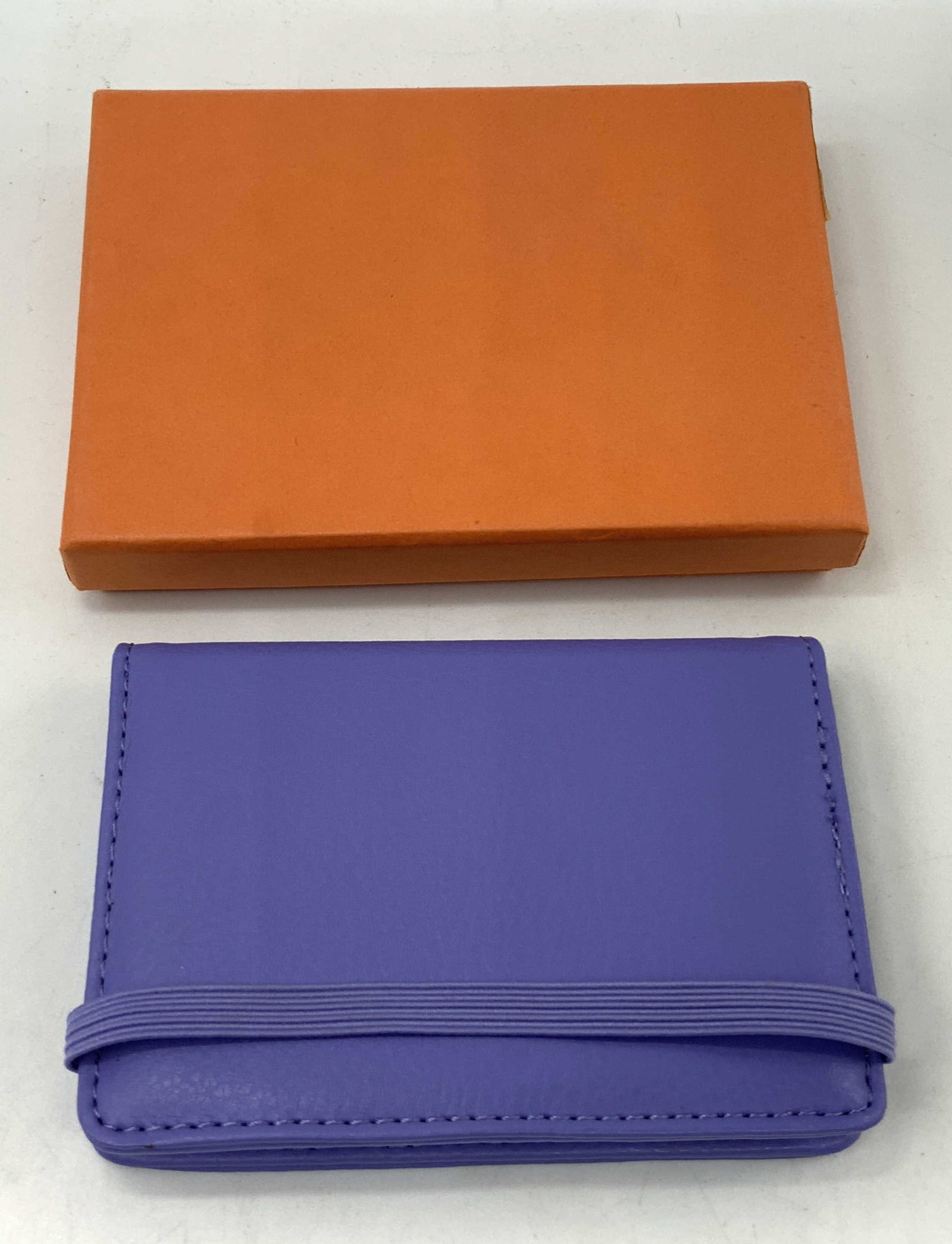 CAMPO MARZIO Design Purple Leather Bi-Fold Wallet: CAMPO MARZIO Design Purple Leather Bi-Fold Wallet Lot comes with orange box & purple leather wallet. Wallet has an elastic band & has plastic compartments to hold cards, licenses, etc. Signed & marked