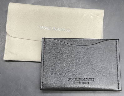DANIEL SWAROVSKI FRANCE Black Bejeweled Wallet: DANIEL SWAROVSKI FRANCE Black Bejeweled Wallet With Dust Bag. Both pieces read DANIEL SWAROVSKI. Wallet reads DANIEL SWAROVSKI MADE IN FRANCE. Crafted from black leather, possibly manmade leather, and