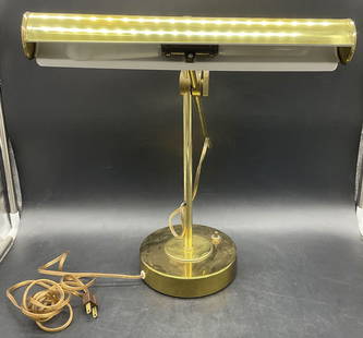 Vintage Portable Brass Bankers Desk Lamp: Vintage Portable Brass Bankers Desk Lamp. Crafted from metal, appears to be brass. Adjustable. Measures approx. 15.5H x 14W in. Corded. Not tested for function. Surface wear and discoloration present.