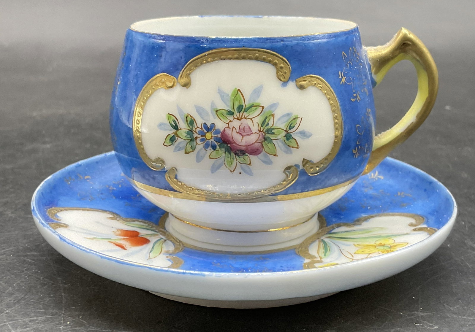 Vtg Hand Painted Porcelain Demitasse Cup & Saucer: Vintage Hand Painted Porcelain Demitasse Cup & Saucer. Undersides marked Made in Occupied Japan. Saucer measures approx, 4L x 4W in. Losses to paint, surface wear, and pitting present. home decor, hom