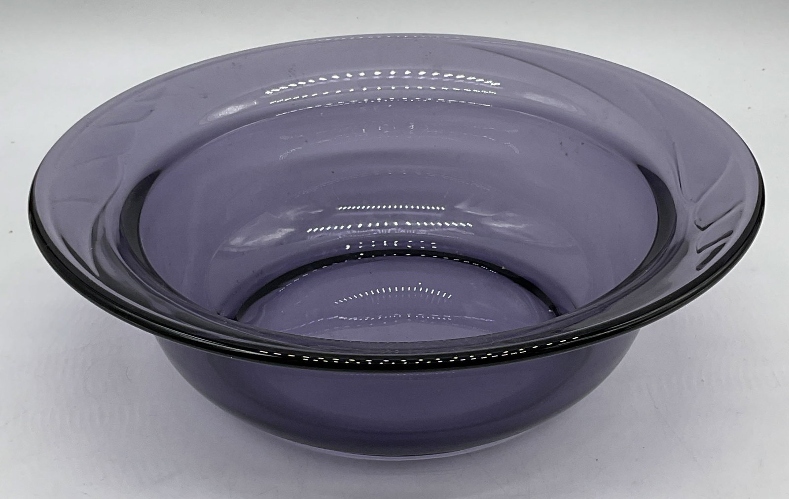 Amethyst Glass Fluted Rim Bowl: Amethyst glass bowl with fluted rim. Measures approx 10 x 3 inches. Thick walled glass, piece has weight. Some scratching observed. Amethyst glass bowl, glass bowl, purple bowl, bowl, homewares, home 