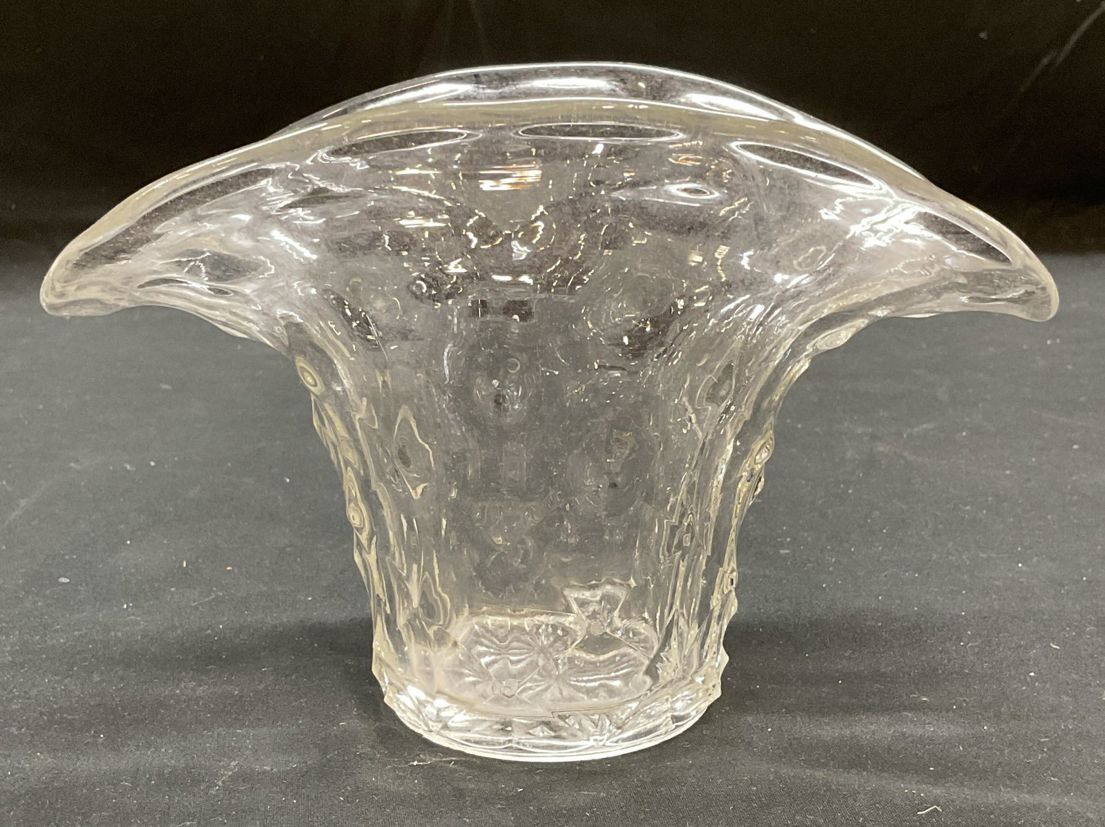 Clear Glass Fluted Fan Vase: Clear glass fan shaped vase with fluted rim and raised detail. Measures approx 7.25 x 5.25 x 5 inches. Some scratching observed. Vase, fluted vase, fan vase, glass vase, homewares, home decor, home ac